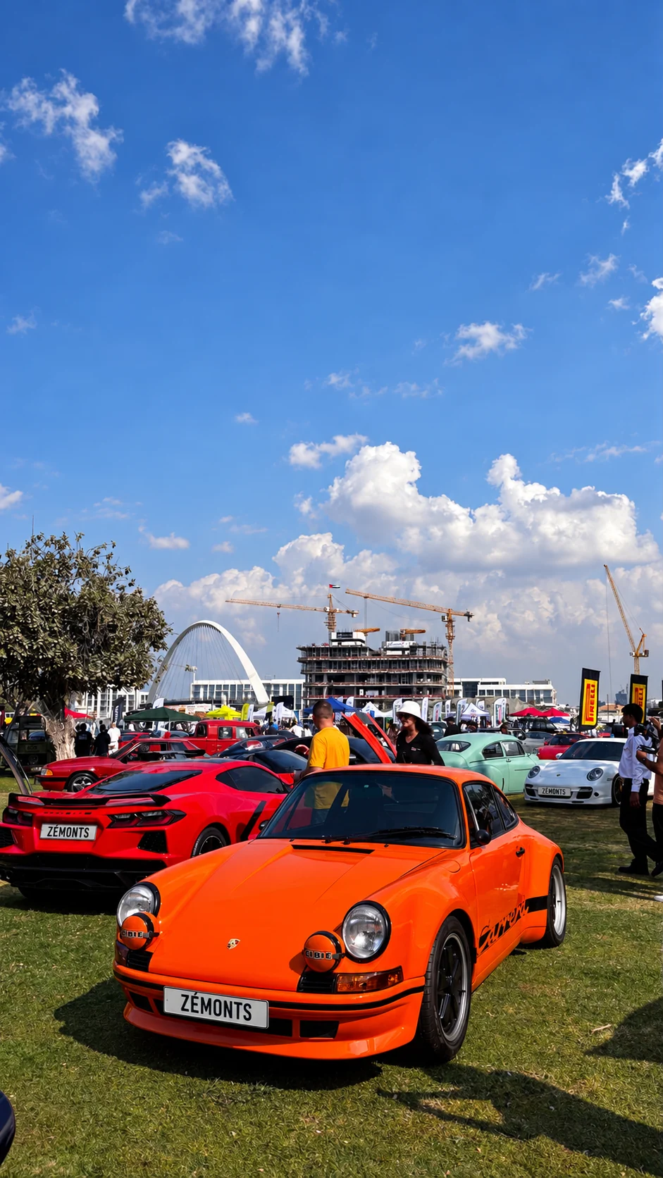 Orange classic Porsche 911 at an outdoor car gathering